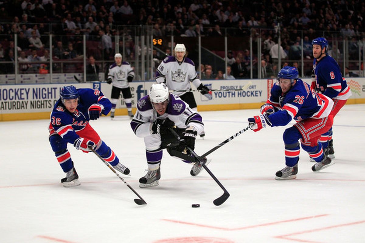 Anze Kopitar #11 (R) of the Los Angeles Kings skates against Mats Zuccarrello #11 (L) and Eric Christensen #26 of the New York Rangers on February 17 2011 in New York City.  (Photo by Chris Trotman/Getty Images)