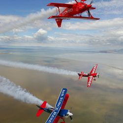 Airshow pilots Sean D. Tucker (Oracle red biplane), Greg Poe (monoplane) and Ed Hamill practice flying their stunt planes over the Great Salt Lake on June 10, 2004, in preparation for an aerobatic show at Hill Airforce Base in Ogden.