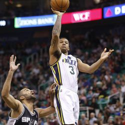 Utah Jazz's point guard Trey Burke (3) floats up a shot over Spurs' Tony Parker as the Utah Jazz and the San Antonio Spurs play Saturday, Dec. 14, 2013 at EnergySolutions Arena in Salt Lake City. The Spurs won 100-84.