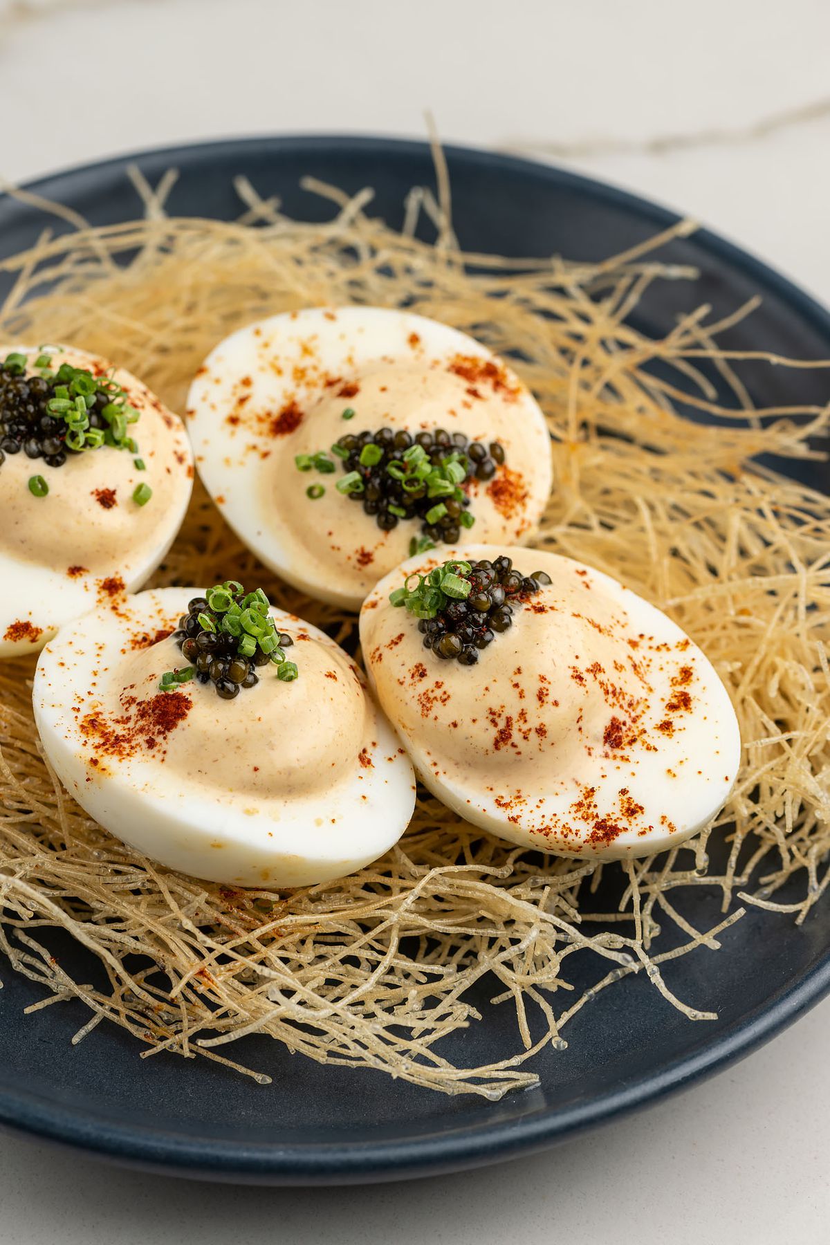 Deviled eggs on a bed of hay.