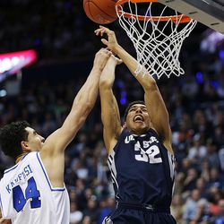 Brigham Young Cougars center Corbin Kaufusi (44) fouls Utah State Aggies forward Grayson Moore (32) at the basket as BYU and Utah State play at the Marriott Center in Provo Wednesday, Dec. 9, 2015.
