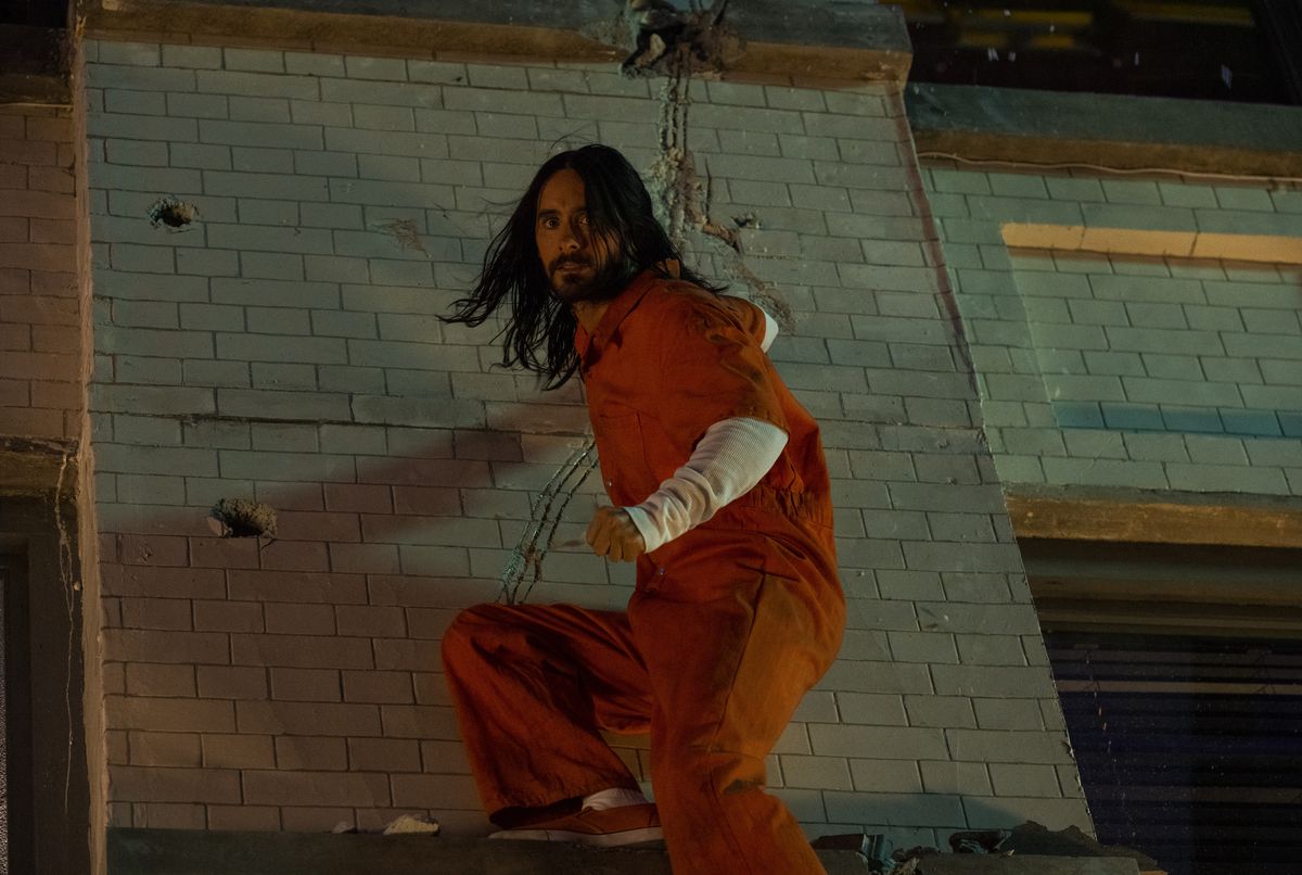 Dr. Michael Morbius (Jared Leto) hangs from a wall