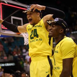 Oregon Ducks players celebrate winning the Pac-12 Conference tournament championship game over the Utah Utes at the MGM Grand Garden Arena in Las Vegas Saturday, March 12, 2016.
