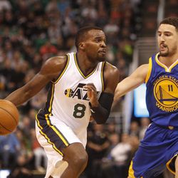Utah Jazz guard Shelvin Mack (8) drives towards the rim as Golden sTate Warriors guard Klay Thompson (11) defends in the first half of an NBA regular season game at the Vivint Arena in Salt Lake City, Wednesday, March 30, 2016.