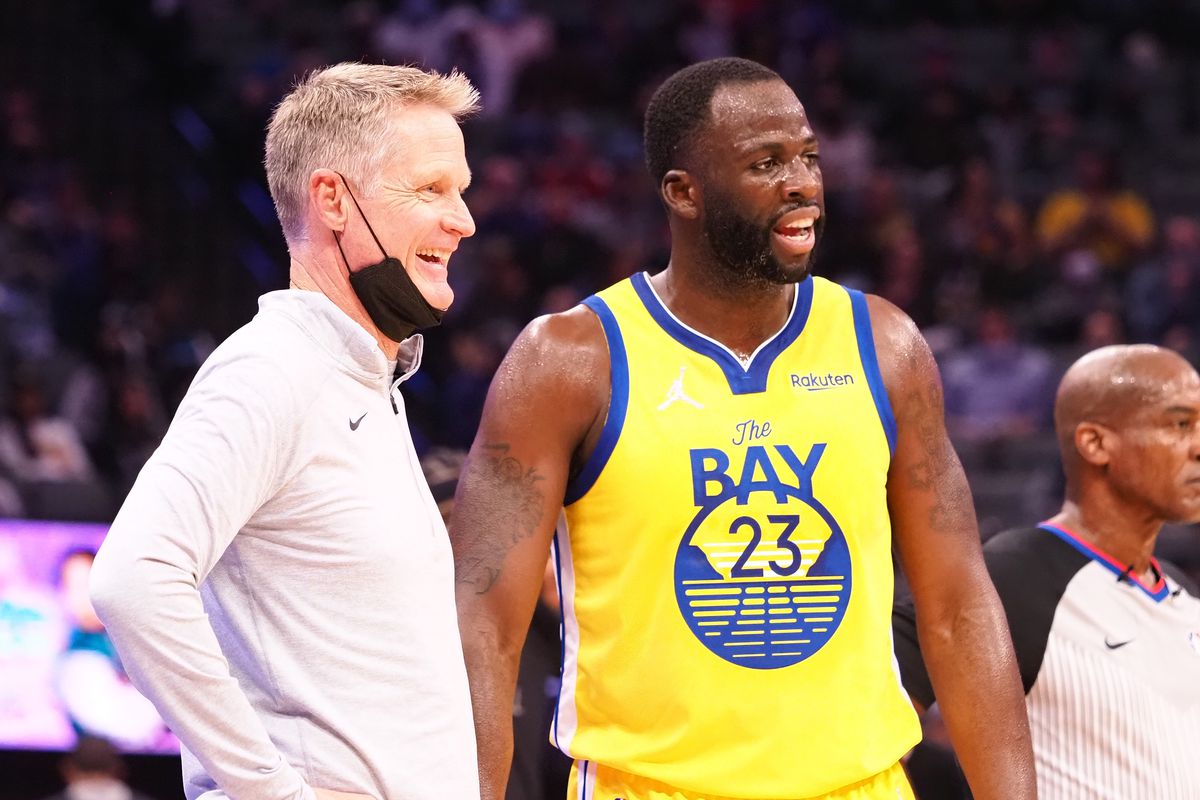 Draymond Green and Steve Kerr talking during a game