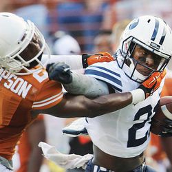 BYU's Jamaal Williams battles to get away from Mykkele Thompson as BYU and Texas play Saturday, Sept. 6, 2014, in Austin, Texas.