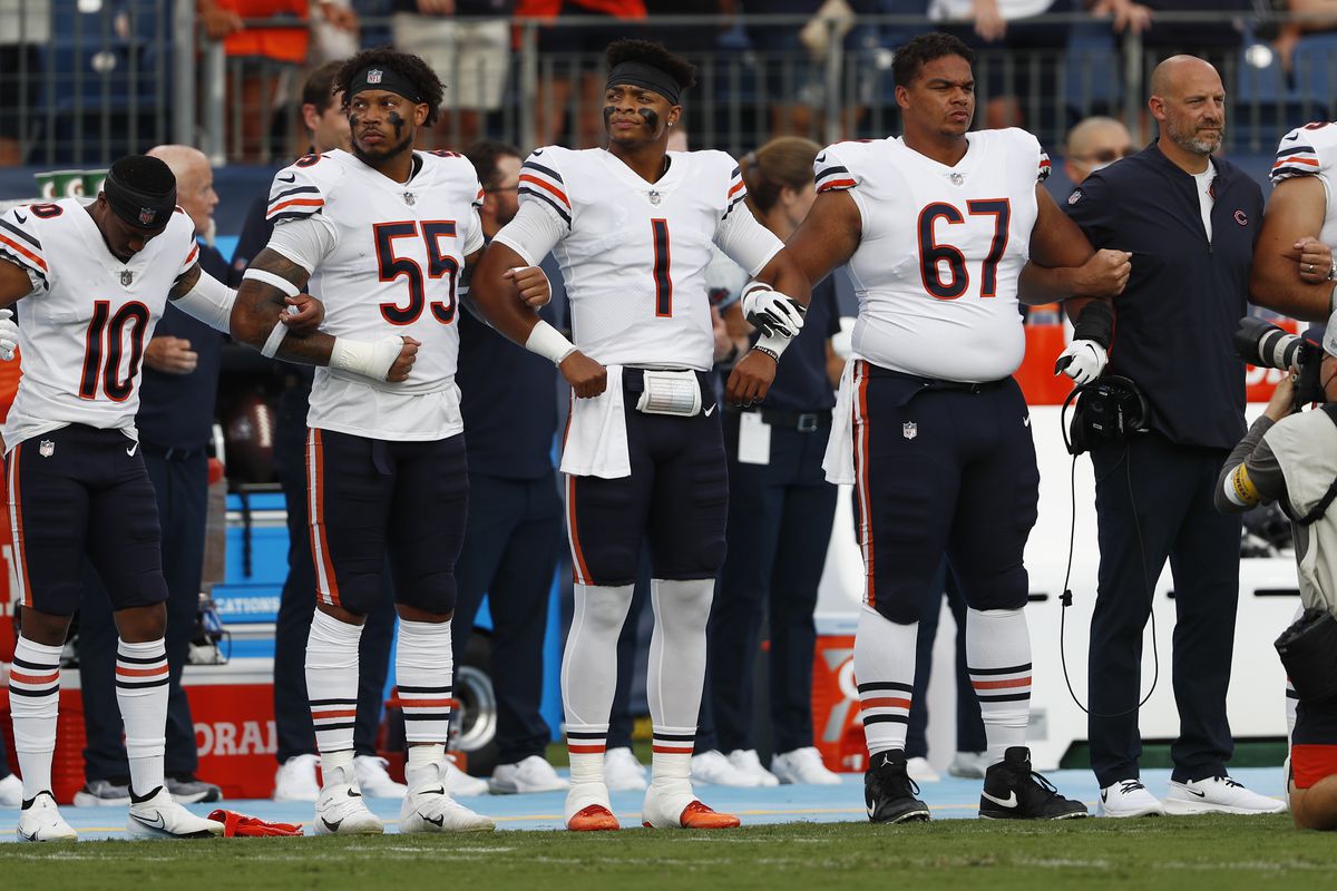 Bears quarterback Justin Fields stands with teammates for the national anthem before Saturday’s game against the Titans. 