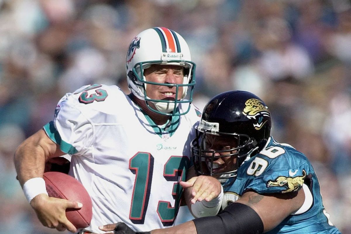 Miami Dolphins quarterback Dan Marino (L) is sacke