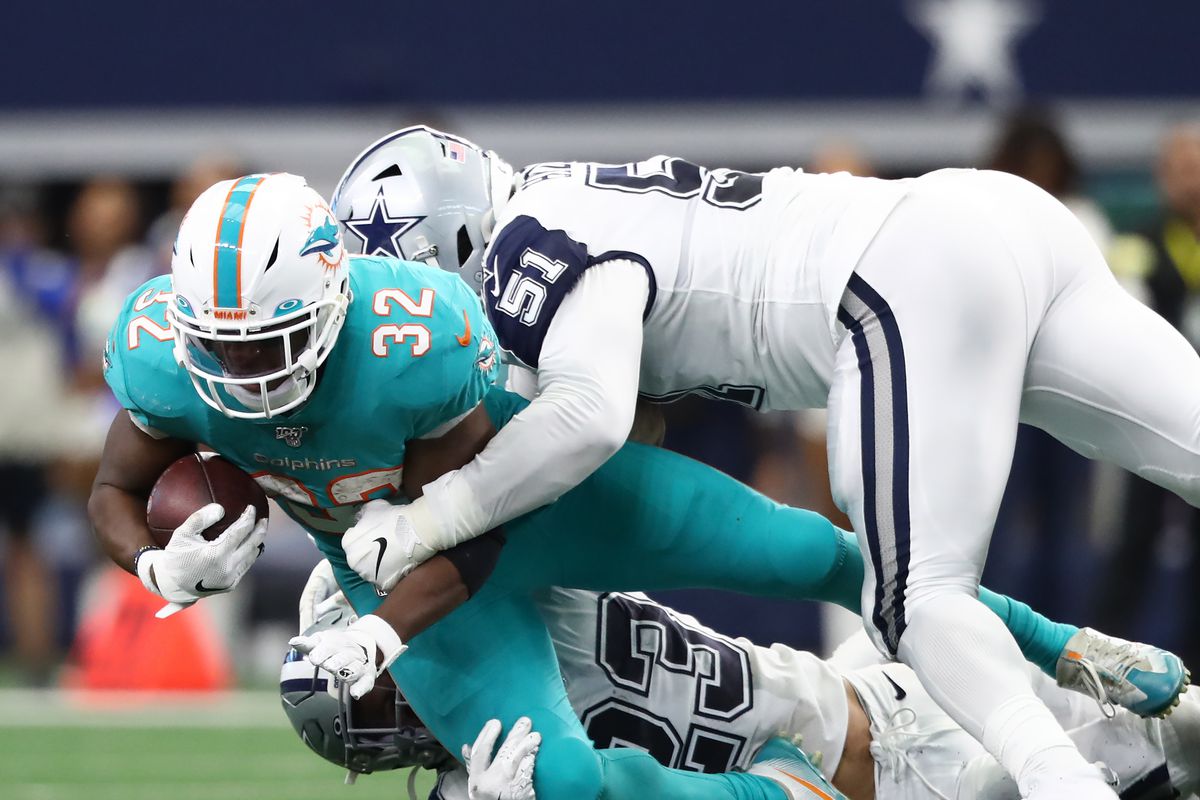 Kenyan Drake of the Miami Dolphins is tackled by Darian Thompson and Kerry Hyder of the Dallas Cowboys in the first quarter at AT&amp;T Stadium on September 22, 2019 in Arlington, Texas.