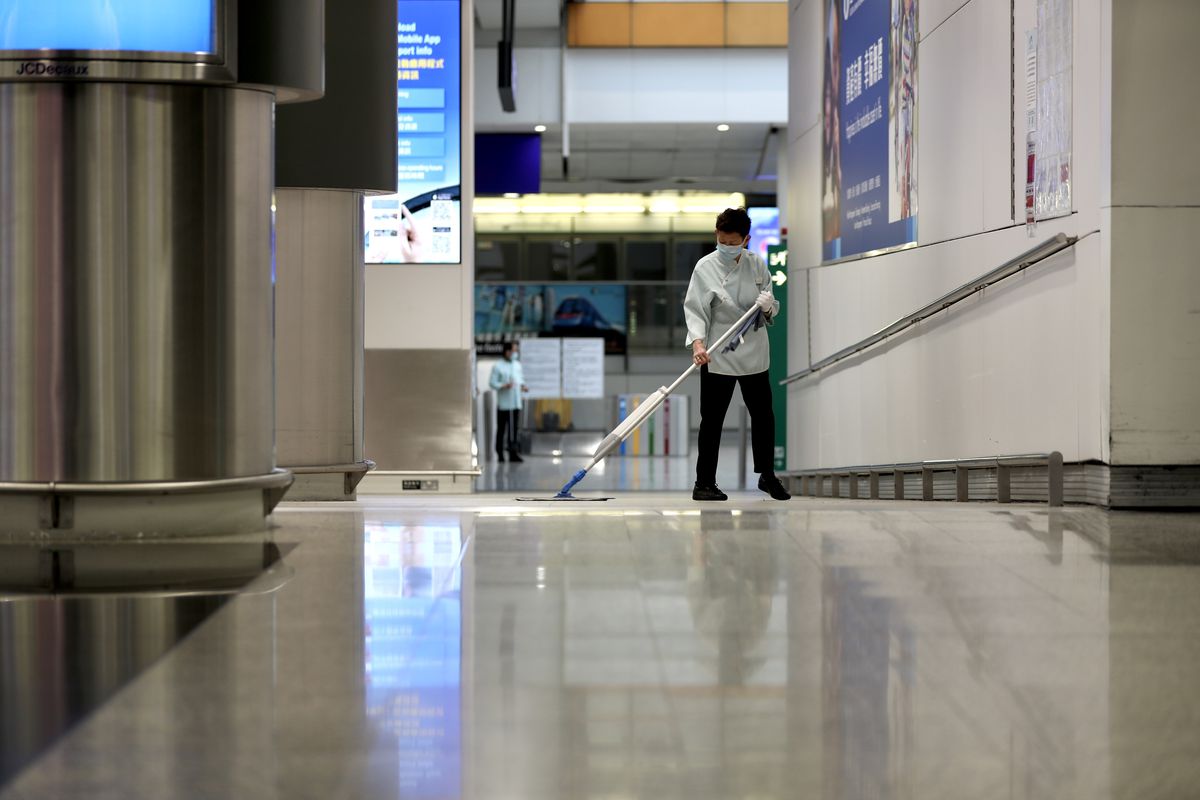 Cleaner wearing mask while cleaning at the Hong Kong Airport...