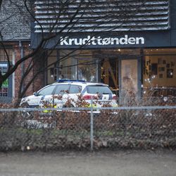 The scene outside the Copenhagen cafe, with bullet marked window, where a gunman opened fire Saturday, Feb. 14, 2015, in what is seen as a likely terror attack against a free speech event organized by an artist who had caricatured the Prophet Muhammad. The police believe there was only one shooter in the attack on a Copenhagen cafe that left one person dead and three police officers wounded during a free speech event. 
