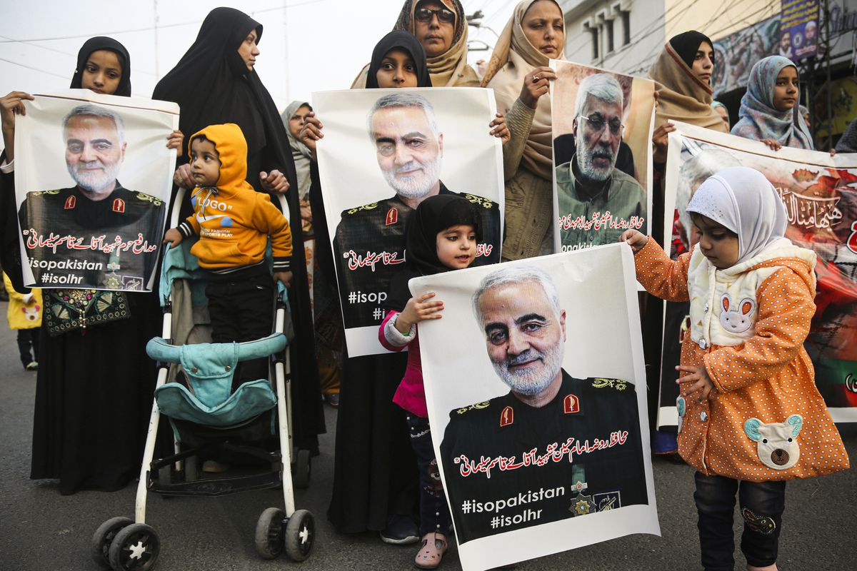 At a protest in Pakistan, women and children hold posters and signs depicting Qassem Soleimani, the Iranian military leader killed in a US airstrike in Iraq.