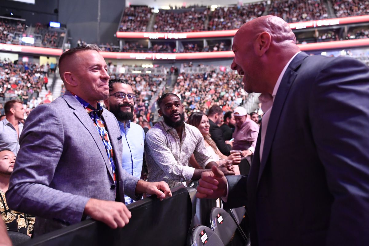 Dana White and Georges St-Pierre have a conversation during UFC 266 in 2021. 