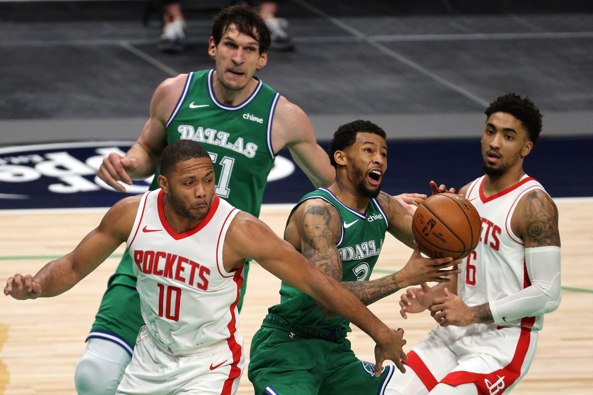 Trey Burke of the Dallas Mavericks controls the ball against Eric Gordon of the Houston Rockets in the second quarter at American Airlines Center on January 23, 2021 in Dallas, Texas.