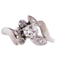 <b>Love Adorned Vintage</b> <a href="https://www.loveadorned.com/jewelry/rings/vintage-14k-white-gold-ring-with-white-diamonds-in-unique-floral-cutout-setting-size-4">14k white gold floral motif ring</a>, $800</a>
