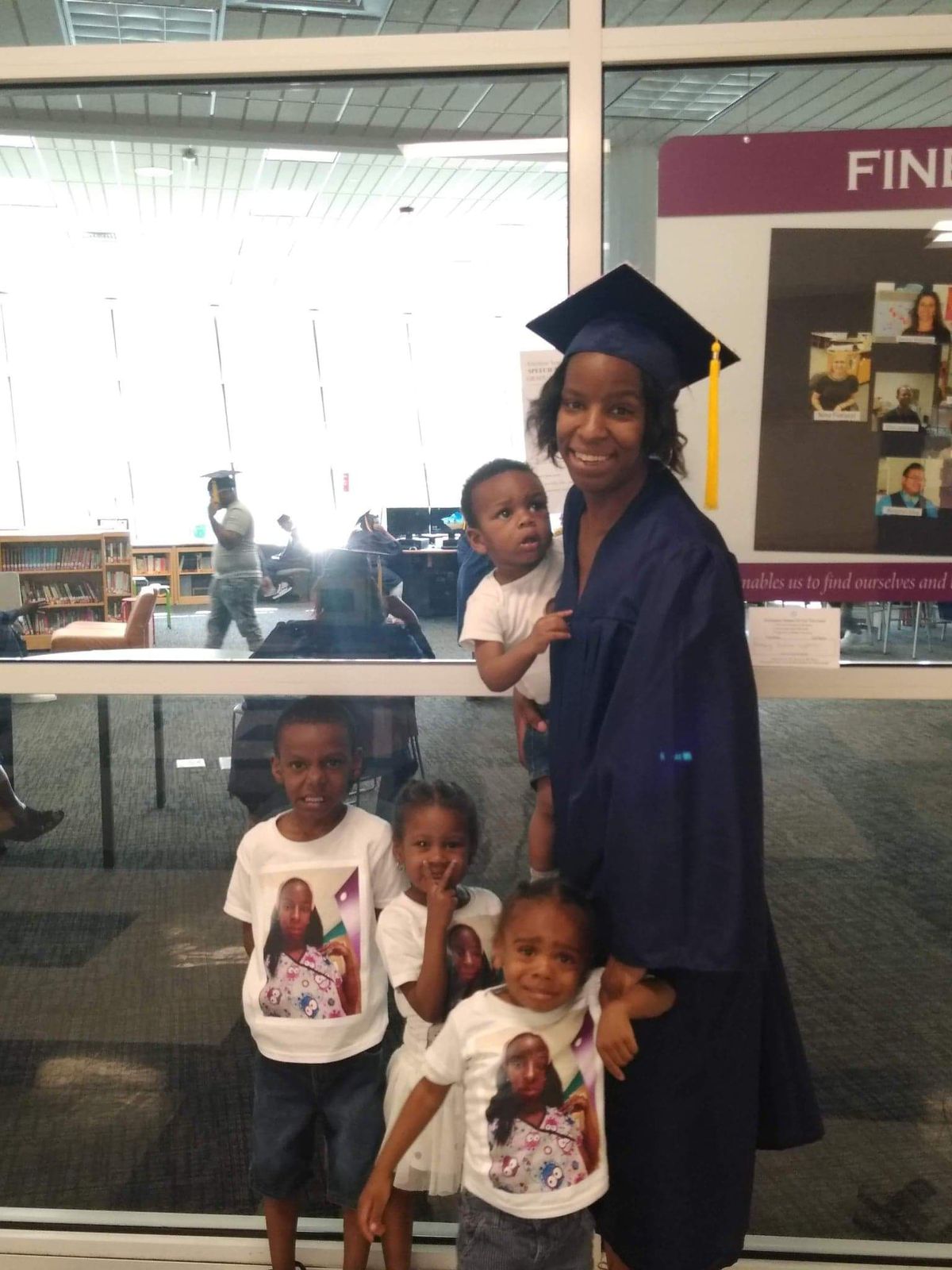 Rosey Lyons, 28, with her four children after graduating high school
