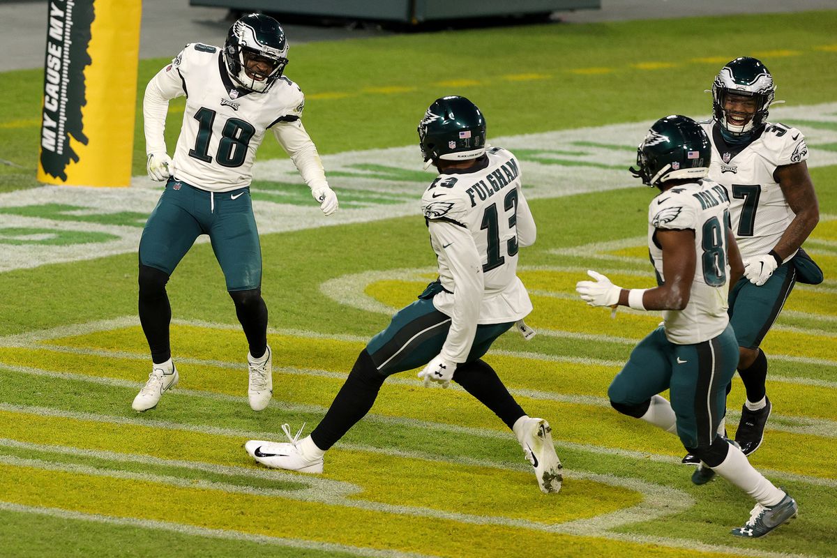 Jalen Reagor #18 of the Philadelphia Eagles celebrates with teammates Travis Fulgham #13 and Greg Ward #84 following a punt return for a touchdown during the fourth quarter of their game against the Green Bay Packers at Lambeau Field on December 06, 2020 in Green Bay, Wisconsin.
