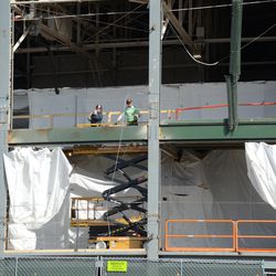 11:23 a.m. Workers in front of the ballpark, above the main gate (Gate F) -
