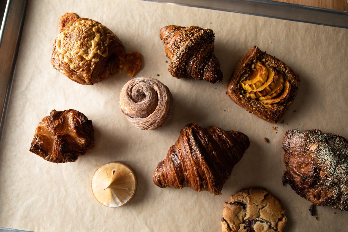 An overhead shot of eight different pastries and cookies and tarts.