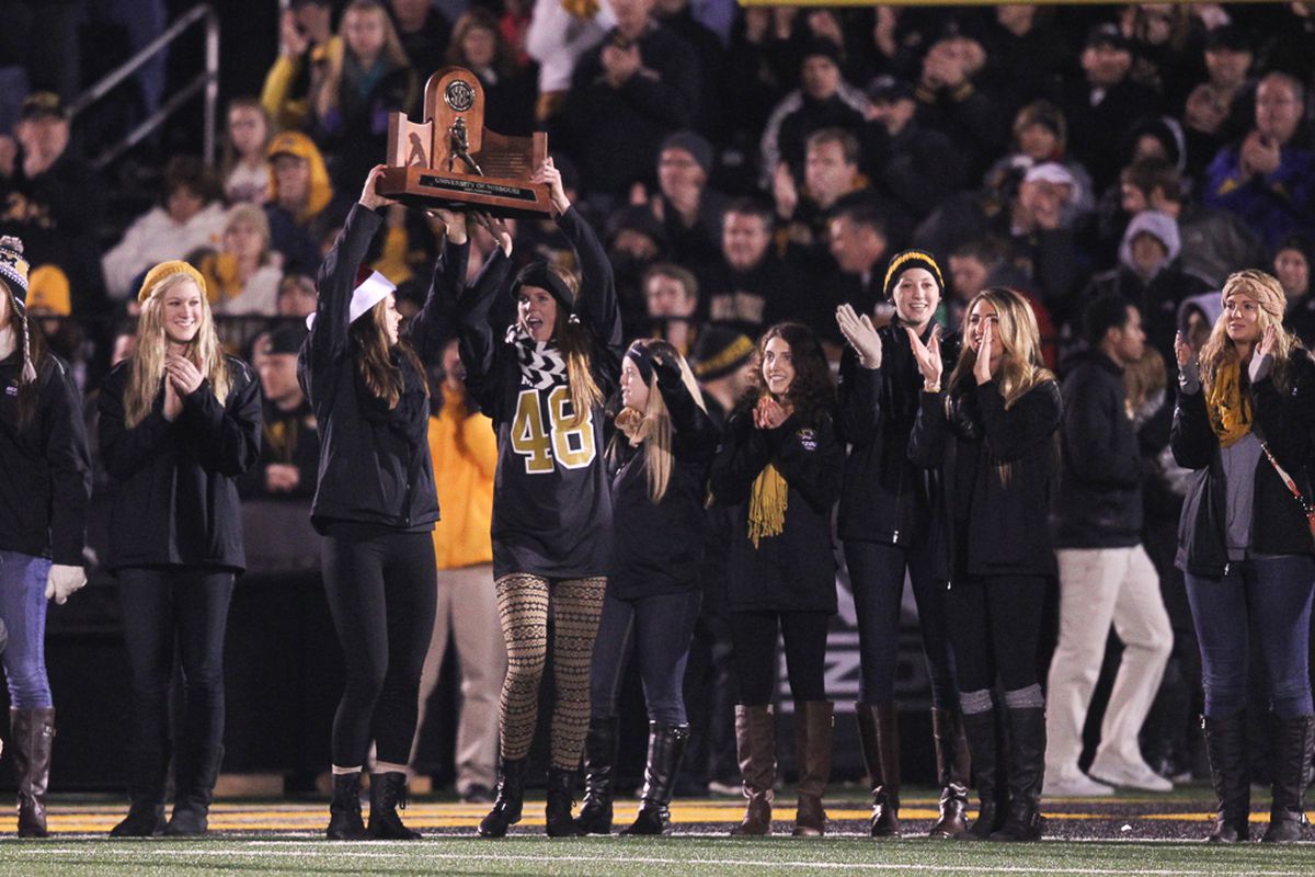 The volleyball team showed off its new trophy at last night's football game.