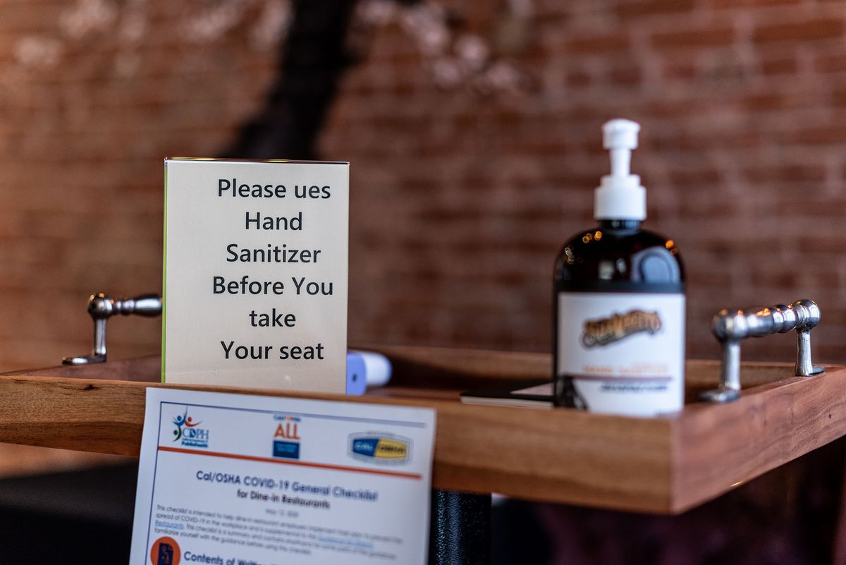 Instructions and hand sanitizer for guests at OMG
