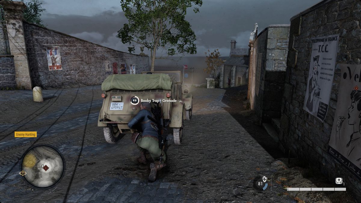 Sniper Elite 5 player booby trapping a Nazi vehicle with a grenade.