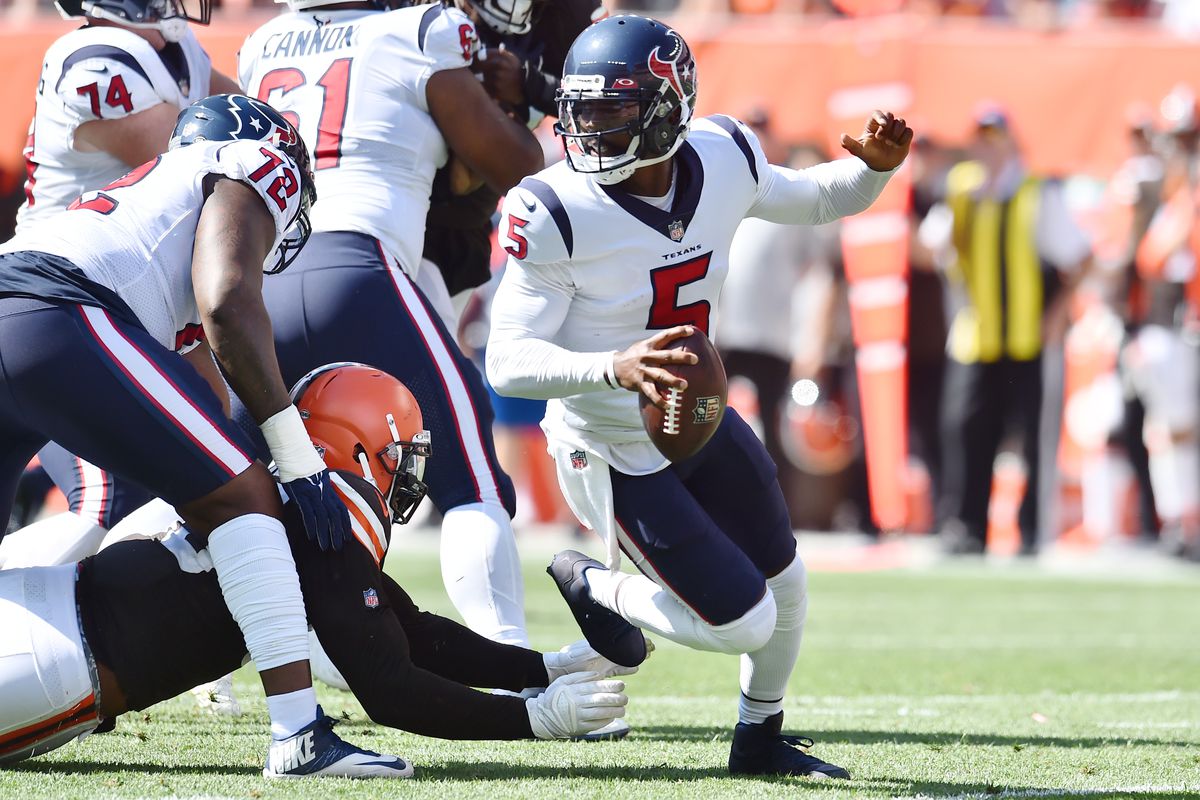 Houston Texans quarterback Tyrod Taylor (5) scrambles from the Cleveland Browns defense during the first half at FirstEnergy Stadium.