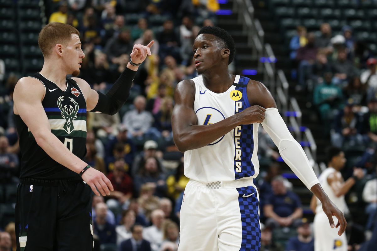 Milwaukee Bucks guard Donte DiVincenzo talks with Indiana Pacers Victor Oladipo during the fourth quarter at Bankers Life Fieldhouse.