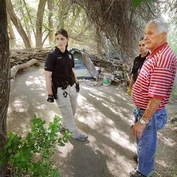 Salt Lake police detectives Charli Goodman, left, and Ron Bruno along with Lowell Bodily from Salt Lake County Health Department stand in a camp as they issue warnings to clear transient camps in City Creek Canyon Monday, June 24, 2013.