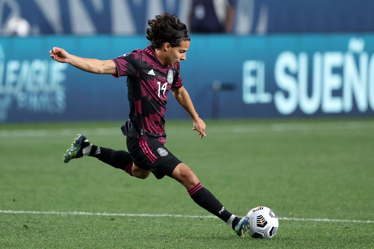 Mexico midfielder Erick Gutierrez (14) kicks the ball in action during the CONCACAF match between Mexico and Costa Rica on June 03, 2021, at Empower Field at Mile High in Denver, CO.