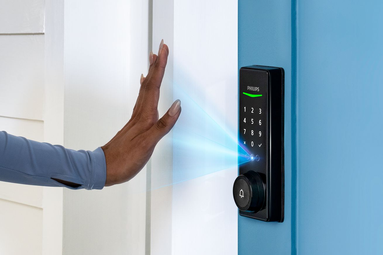 A photo scanning their hand with Philips’ Palm Recognition Smart Deadbolt