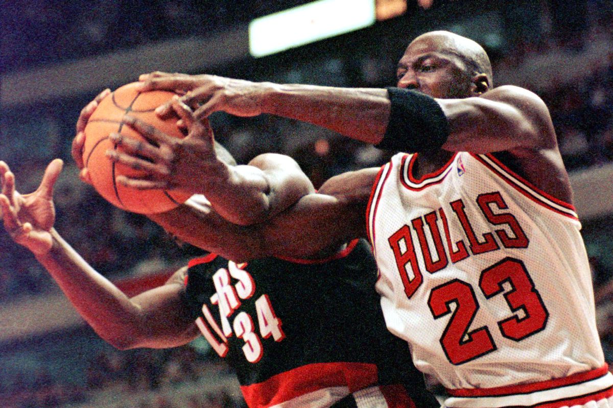 Chicago Bulls guard Michael Jordan(R) fights for a