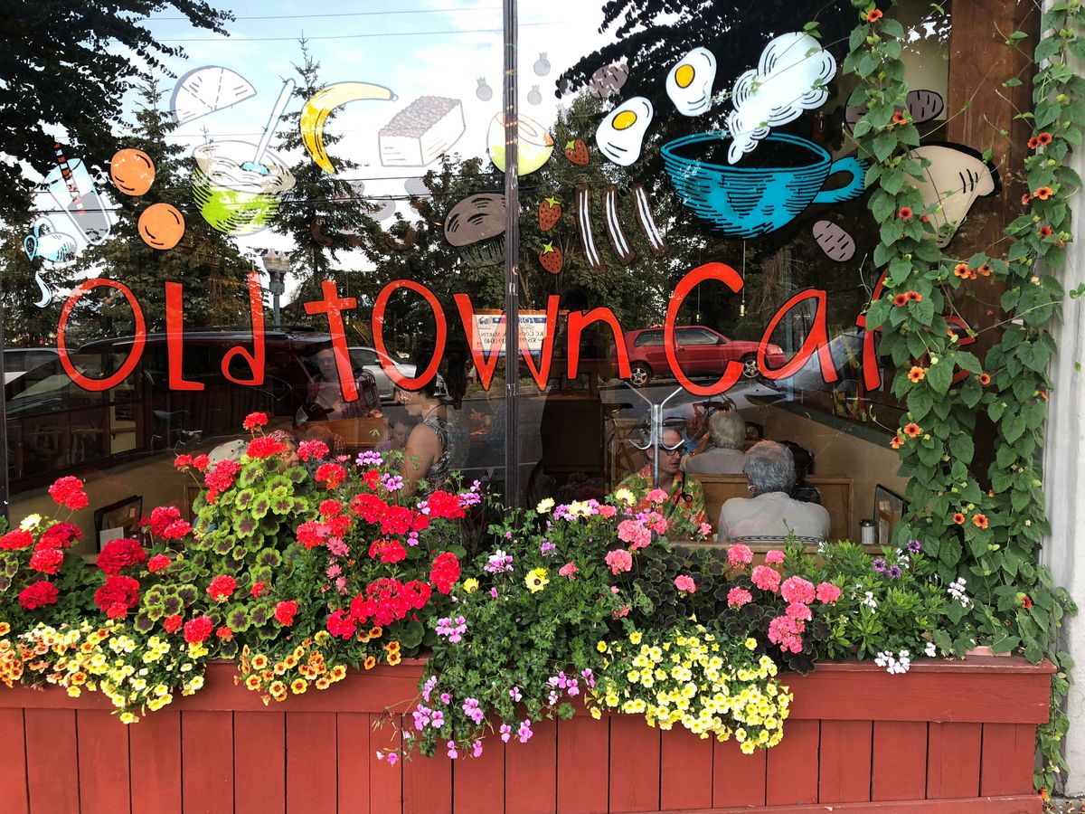 The exterior of Old Town Cafe, with flower boxes and the cafe’s name on the window.