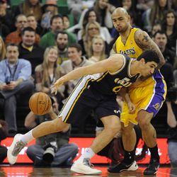 Utah Jazz center Enes Kanter (0) loses the ball while driving to the basket as Los Angeles Lakers center Robert Sacre (50) defends during a game at EnergySolutions Arena on Friday, Dec. 27, 2013.