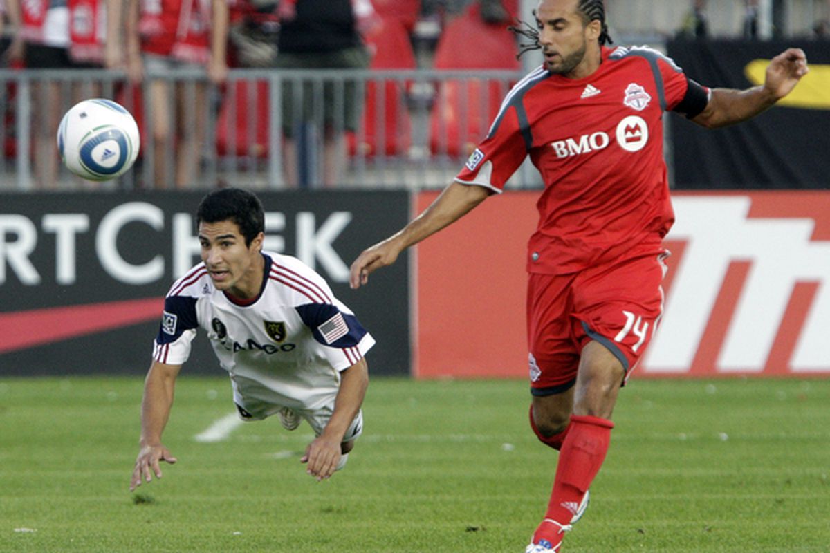 TORONTO - AUGUST 28: Dwayne De Rosario #14 of Toronto FC trips up Tony Beltran #2 of Real Salt Lake during a MLS game at BMO Field August 28 2010 in Toronto Ontario Canada. (Photo by Abelimages/Getty Images)