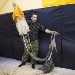 In this photo taken on Friday, Oct. 28, 2016, former paratrooper Ruslan Korastylyov shows how a parachute works during a training in Verkhnyaya Pyshma, just outside Yekaterinburg, Russia. The training has been run by Yunarmia (Young Army), an organization sponsored by the Russian military that aims to encourage patriotism among the Russian youth. 