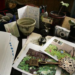 Tools of a garden designer's trade adorn the desktop of Janese Reed, of Kansas City, Missouri, January 28, 2010. Items include her garden journal, left, compass, garden photographs, her digital camera, a sedum plant and a Caladium bulb sprouting just a single leaf. 