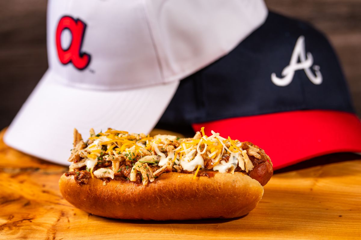 The ‘Douille Dog made with Andouille sausage topped with beef chili, onion and cheddar cheese at Truist Park ballpark in Georgia, home of the Atlanta Braves.