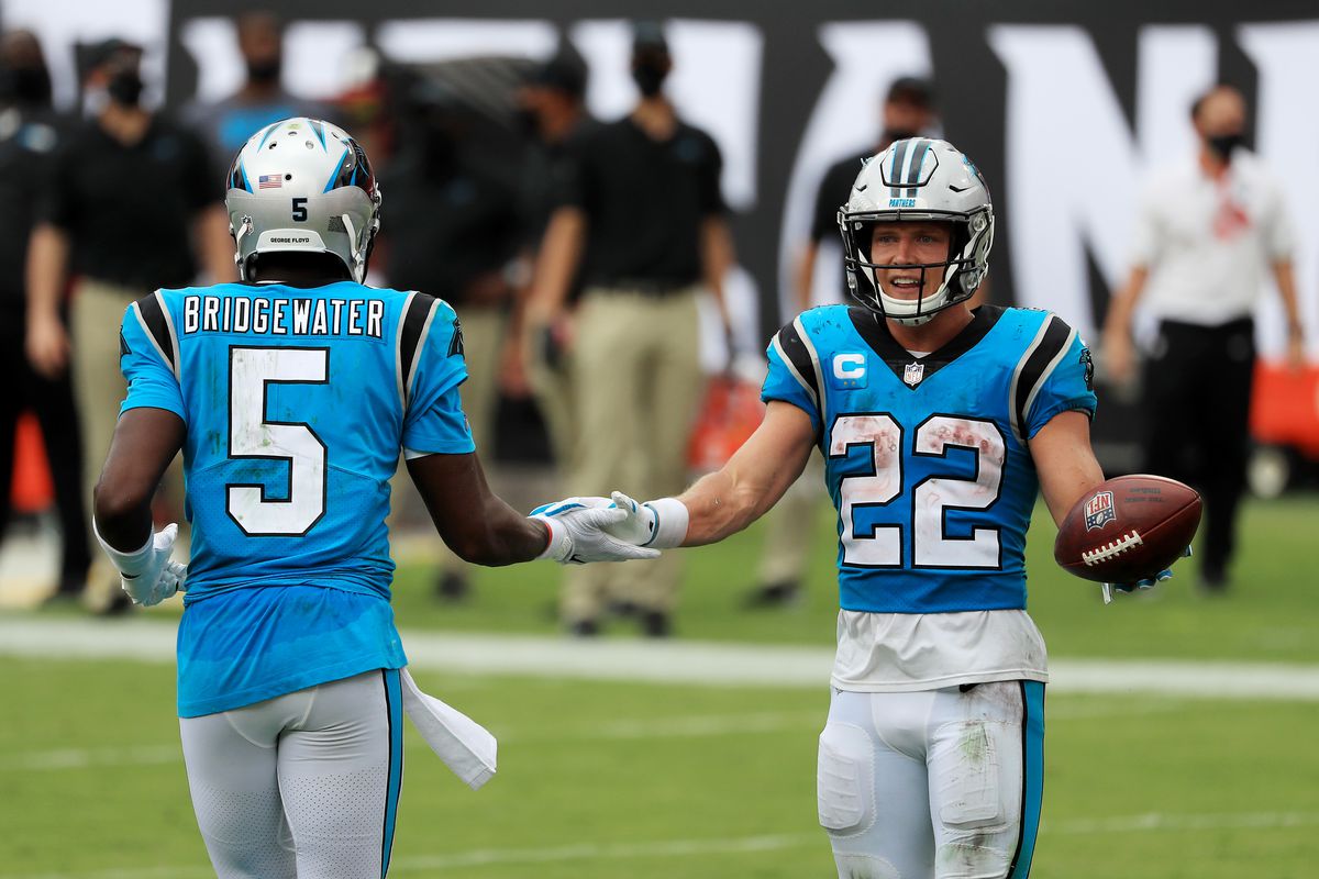 Christian McCaffrey #22 of the Carolina Panthers celebrates with Teddy Bridgewater #5 after scoring a touchdown during the third quarter against the Tampa Bay Buccaneers at Raymond James Stadium on September 20, 2020 in Tampa, Florida.