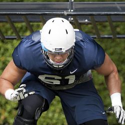 Offensive lineman Quinn Lawlor runs a drill during a BYU football practice at BYU's practice fields Thursday, Aug. 14, 2014.