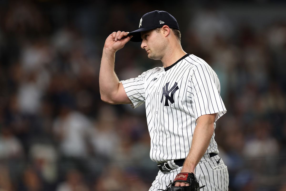 Starting pitcher Gerrit Cole of the New York Yankees tips his hat to a standing ovation by the crowd after leaving the game in the 8th inning against the Seattle Mariners at Yankee Stadium on June 17, 2023 in New York City.