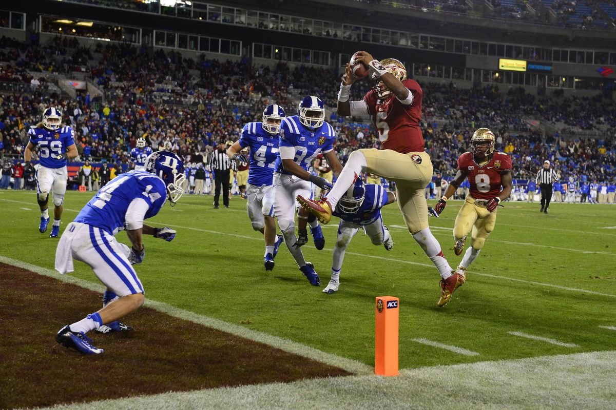 Charlotte, NC, USA; Florida State Seminoles quarterback Jameis Winston (5) scores a touchdown as Duke Blue Devils cornerback Bryon Fields (14) and linebacker David Helton (47) and defensive end Kenny Anunike (84) and safety Dwayne Norman (40) defend 