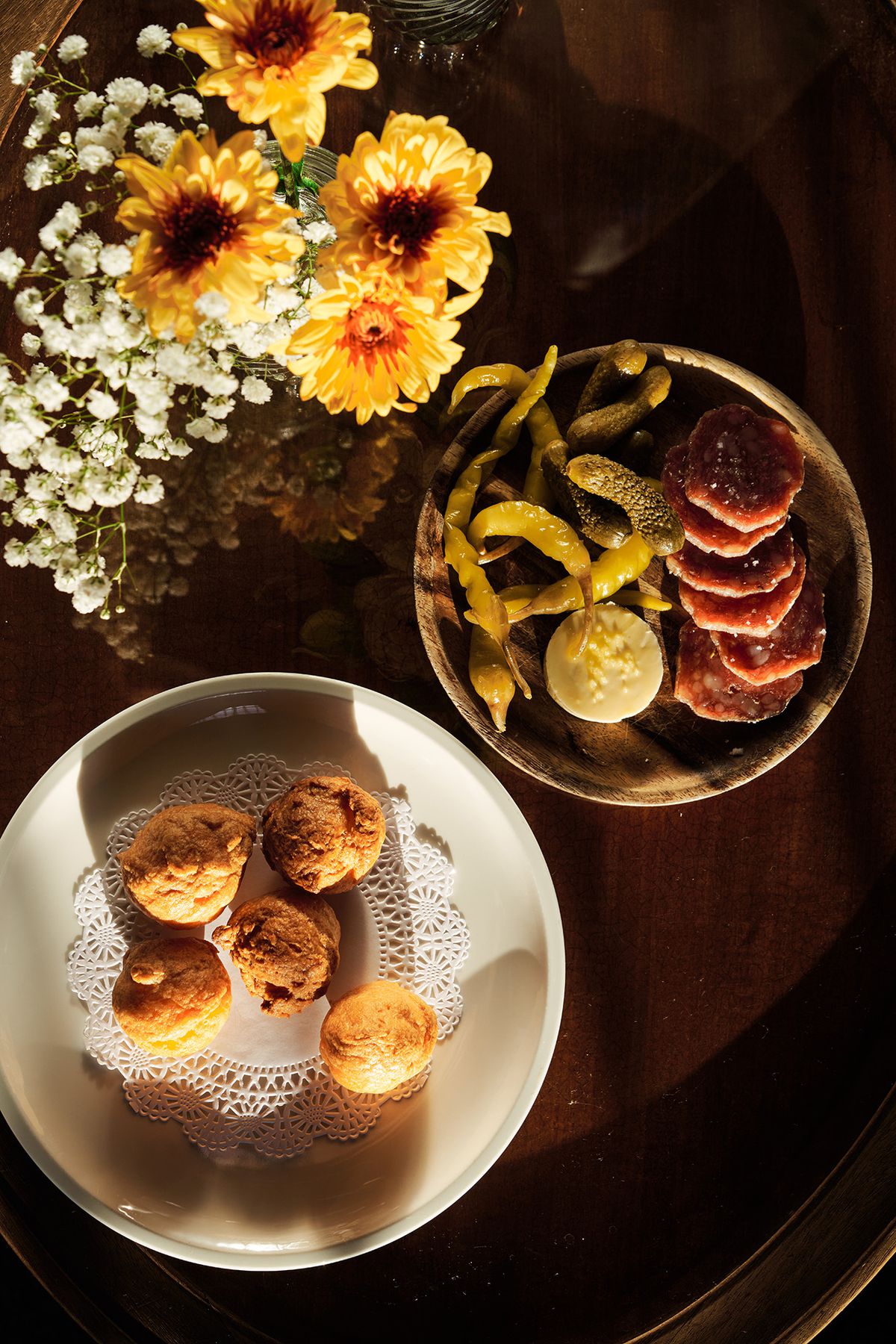 Gougeres and sausages with butter and pickles at Le Champ.