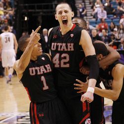 Senior Jason Washburn celebrates with teammates after Utah's 79-69 overtime victory over Cal in the Pac-12 tournament.