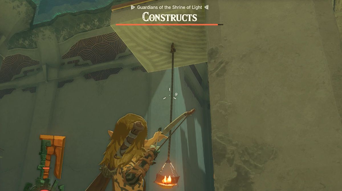Link fires a bow at a hanging torch in the Otak Shrine 'Proving Grounds: Traps' quest in Zelda: Tears of the Kingdom