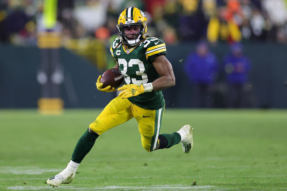 Aaron Jones #33 of the Green Bay Packers runs for yards during a game against the Los Angeles Rams at Lambeau Field on December 19, 2022 in Green Bay, Wisconsin. The Packers defeated the Rams 24-12.