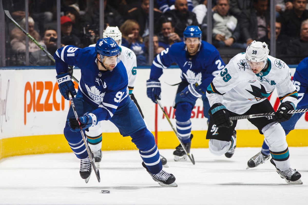 John Tavares #91 of the Toronto Maple Leafs skates against Logan Couture #39 of the San Jose Sharks during the third period at the Scotiabank Arena on November 28, 2018 in Toronto, Ontario, Canada.