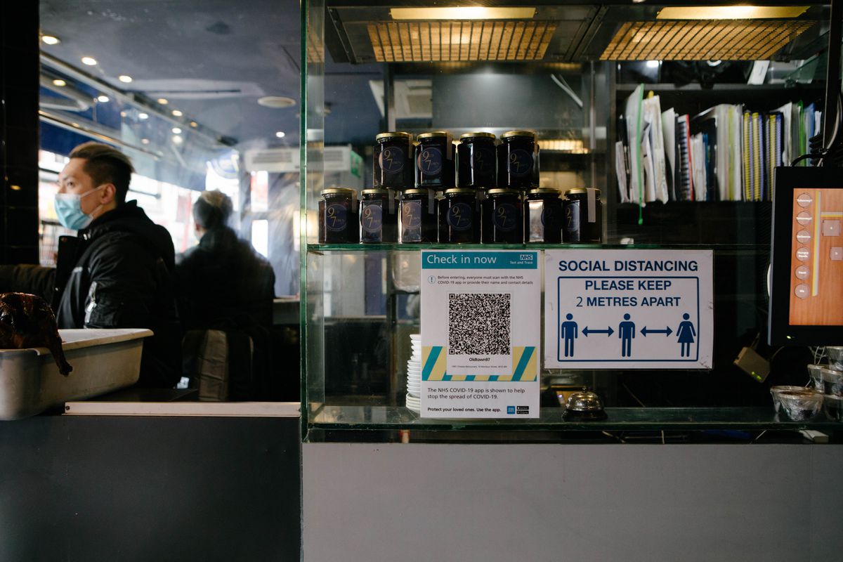 Social distancing inside restaurants looks set to remain in place until at least mid-summer, as indicated by a QR code for track and trace and a sign reminding guests to maintain 2 metre distancing inside Old Town 97 in Chinatown London