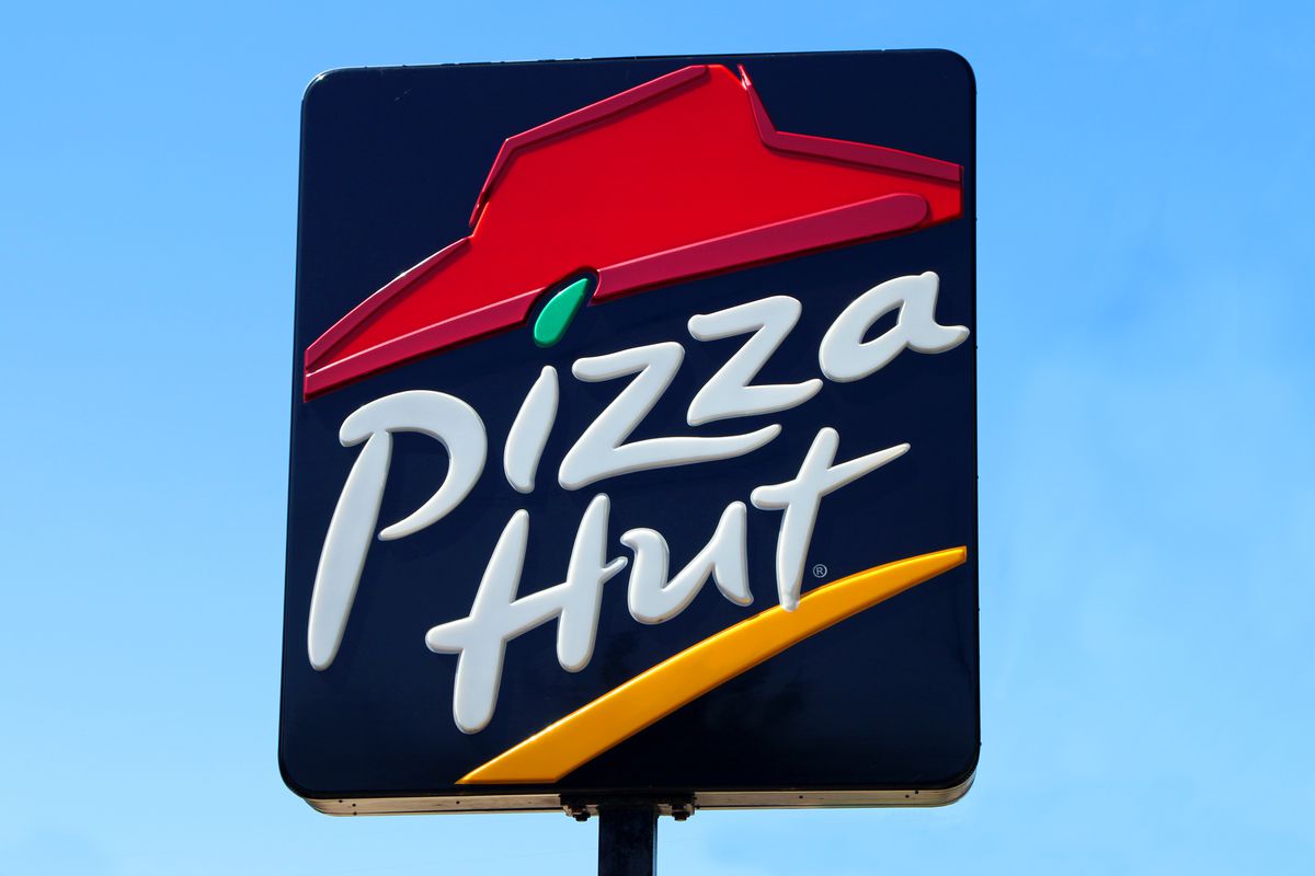 A Pizza Hut sign high above a restaurant