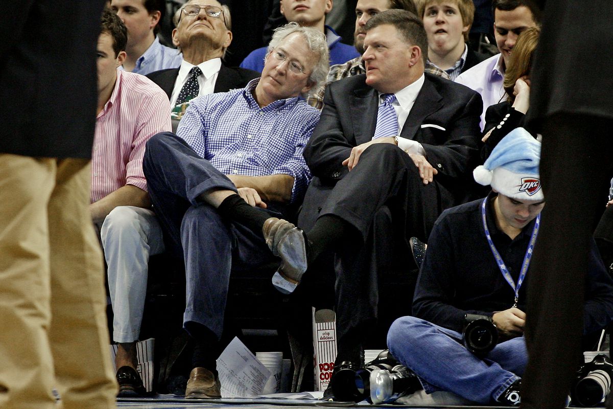 McClendon sits left, in the checkered blue shirt.